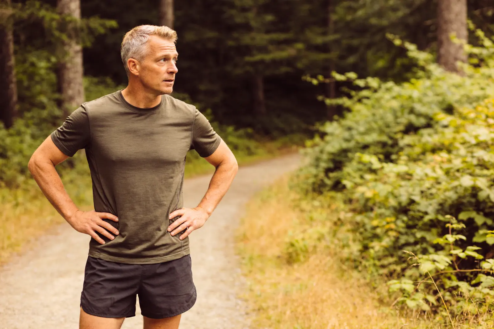 Fit man in his early forties checking his progress after a morning walk outdoors
