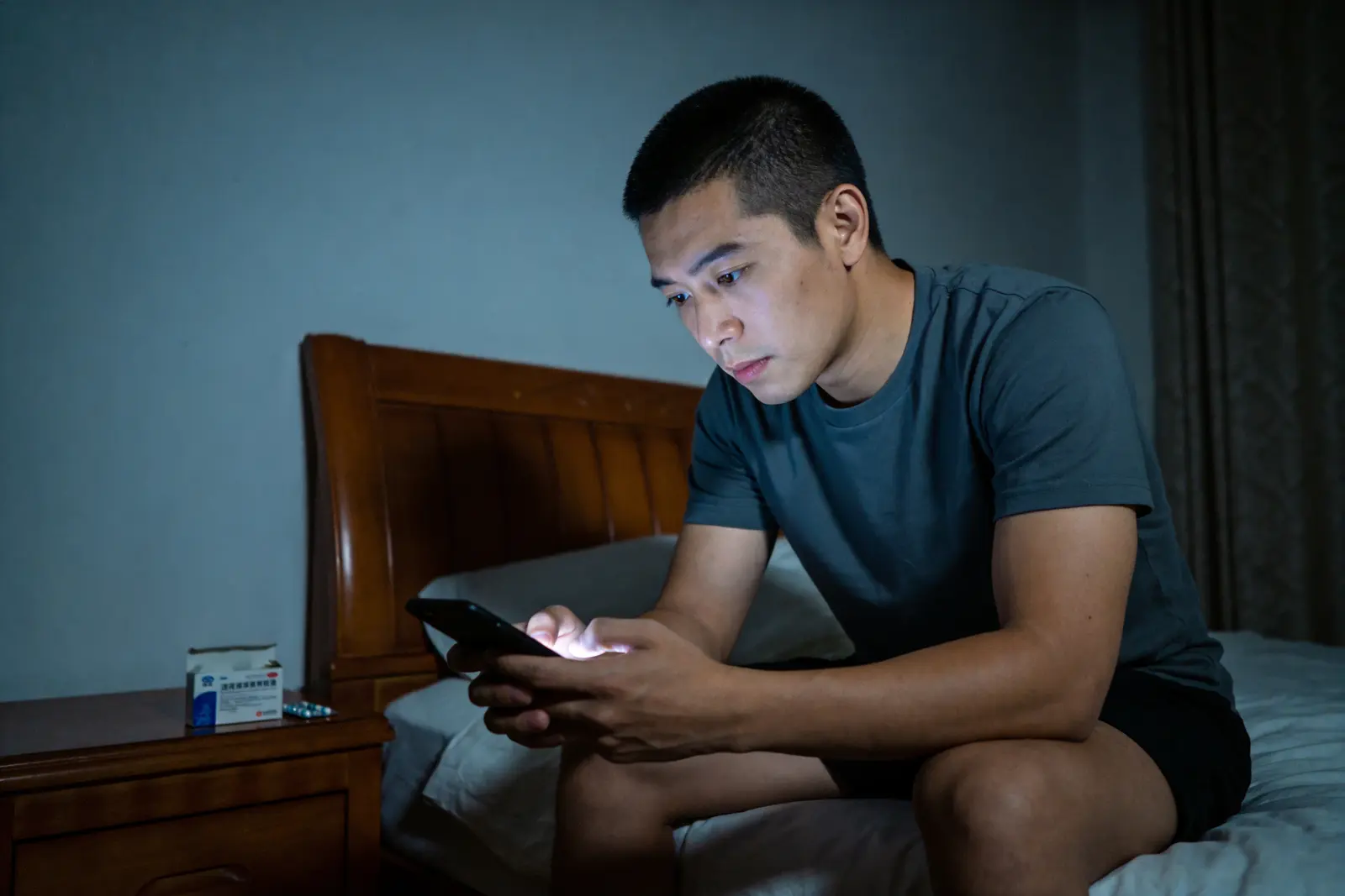 A man alone at night looking at a phone, the frictionless refill model